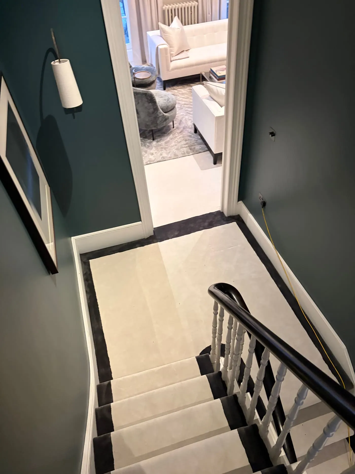 Cream carpet with black border on a landing at the top of the stairs