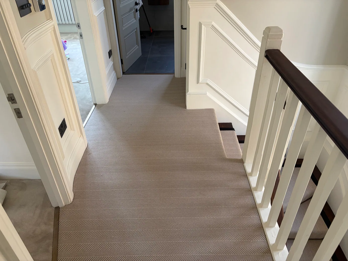Fitted stair runner and landing carpet around a staircase and hallway
