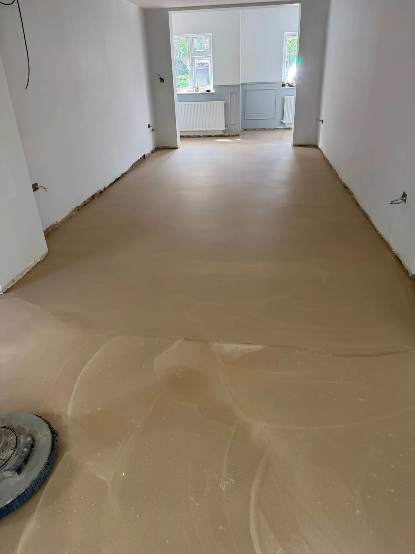 Freshly levelled screed subfloor drying before flooring is fitted