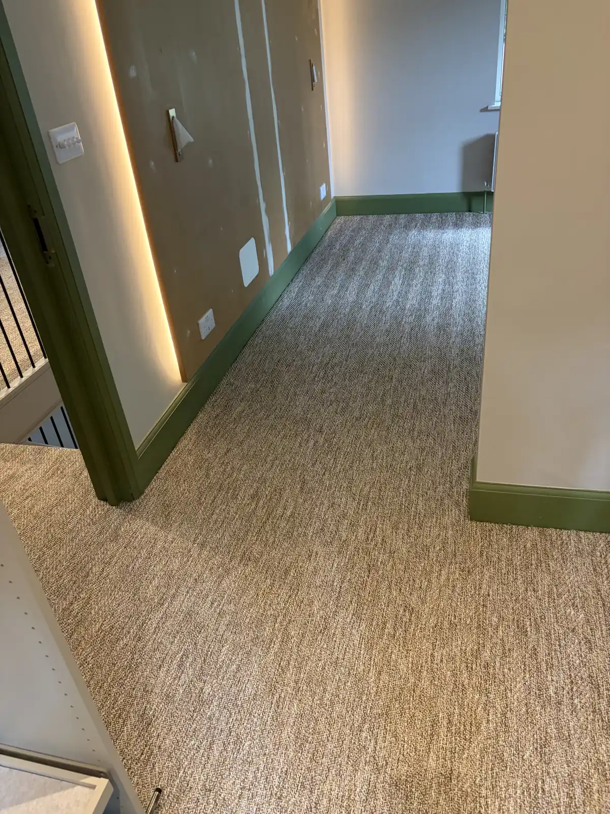 Natural loop carpet fitted along an upstairs hallway