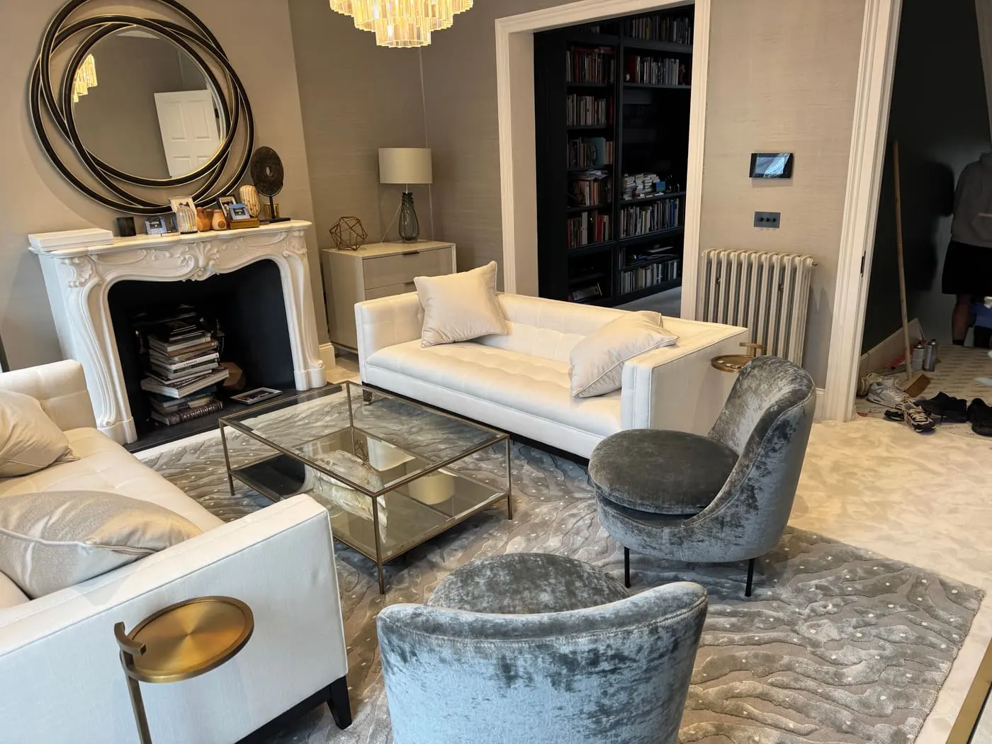 Neutral fitted carpet in a living room with white sofas and a marble fireplace