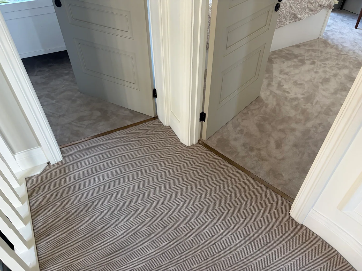 Landing carpet and stair runner threshold detail between adjoining rooms